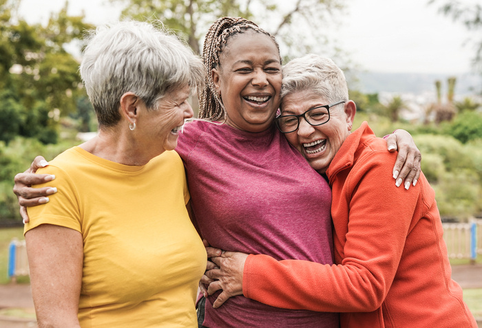 3 woman laughing and hugging